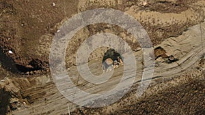 Aerial view of a tractor that performs earthworks at a construction site