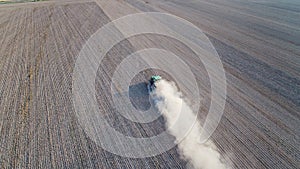 Aerial view on tractor ploughing field.