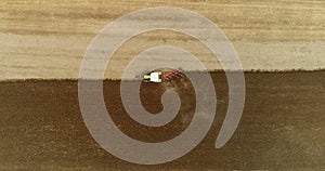 Aerial view of tractor plowing field.