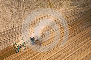 Aerial View. Tractor Plowing Field. Beginning Of Agricultural Spring Season. Cultivator Pulled By A Tractor In