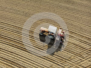 Aerial view of a tractor plowing the fields, aerial view, plowing, sowing, harvest. Agriculture and Farming, campaign.