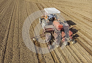 Aerial view of a tractor plowing the fields, aerial view, plowing, sowing, harvest. Agriculture and Farming, campaign.