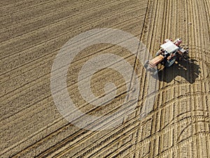 Aerial view of a tractor plowing the fields, aerial view, plowing, sowing, harvest. Agriculture and Farming, campaign.