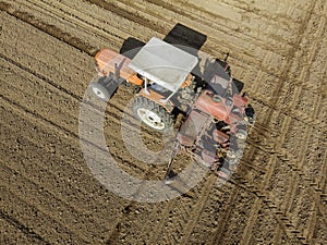 Aerial view of a tractor plowing the fields, aerial view, plowing, sowing, harvest. Agriculture and Farming, campaign.