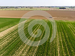 Aerial view of a tractor plowing the fields, aerial view, plowing, sowing, harvest. Agriculture and Farming, campaign.