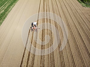 Aerial view of a tractor plowing the fields, aerial view, plowing, sowing, harvest. Agriculture and Farming, campaign.