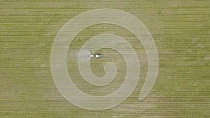 An Aerial View of a tractor spraying a farmers apple Crop, In 4K.