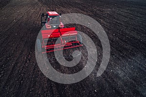 Aerial view of tractor working on the harvest field