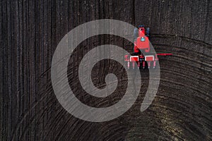 Aerial view of tractor working on the harvest field