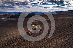 Aerial view of tractor working on the harvest field