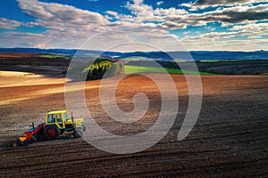 Aerial view of tractors working on the harvest field