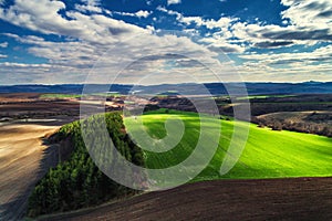 Aerial view of tractors working on the harvest field