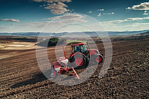 Aerial view of tractors working on the harvest field