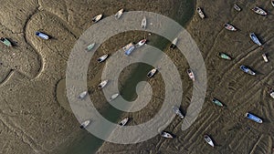 Traditional fish boats stranded on mudflats photo