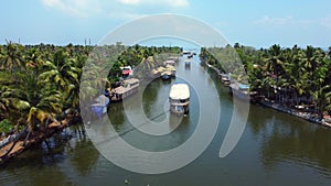 Aerial view of traditional houseboat cruising Kerala backwaters. Travel India