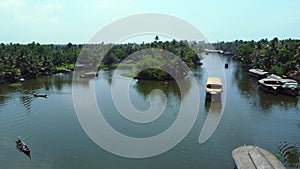 Aerial view of traditional houseboat cruising Kerala backwaters. Travel India