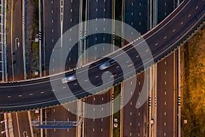 Aerial view traffic car transportation freeway motorway and ring road at twilight