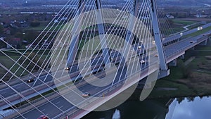 Aerial view Traffic moving on the bridge at dusk in the city of Krakow in Poland. Close-up of a modern cable-stayed