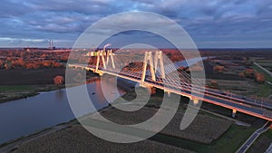 Aerial view Traffic moving on the bridge at dusk in the city of Krakow in Poland. Close-up of a modern cable-stayed