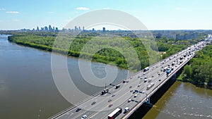 Aerial view of traffic moving on a massive bridge over the Vistula River in Warsaw. Highway passes through the river and leads to