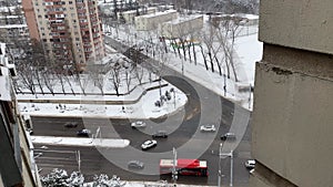 Aerial view on the traffic from the top of multistorey block of flats building