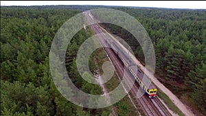 Aerial view of train over railway in the forest.