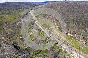 Aerial view of a train line and forest regeneration in regional Australia