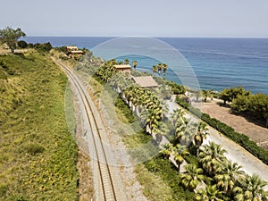 Aerial view of train tracks crossing the coast with sea