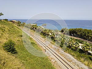 Aerial view of train tracks crossing the coast with sea