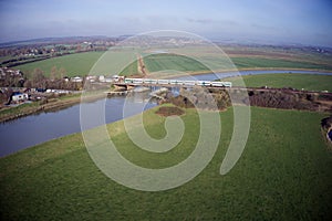 Aerial view of a train travelling over the railway bridge