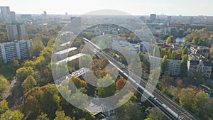 Aerial view of trains passing by each other on multitrack railway line in autumn city. Berlin, Germany