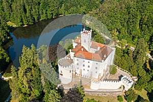 Aerial view of Trakoscan castle surrounded by the lake and forested hills