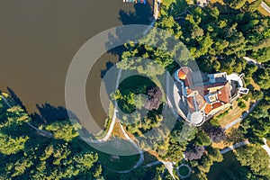 Aerial view of Trakoscan castle surrounded by the lake and forested hills