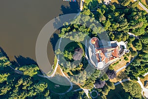 Aerial view of Trakoscan castle surrounded by the lake and forested hills