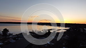 Aerial view of a tranquil lake illuminated by a vibrant sunset in Beaver Island, Michigan