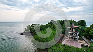 Aerial view of a tranquil scene featuring a tower nestled among lush trees, Burung Island