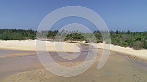 Aerial view of a transparent turquoise sea with beautiful waves at sunny day in summer season Tropical nature landscape from drone