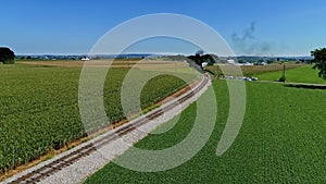 Aerial View Traveling In Front of An Antique Steam Passenger Train, Blowing Black Smoke