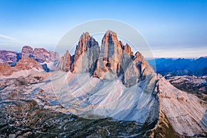 Aerial view of Tre Cime di Lavaredo pinked colored during sunset. Dolomites, Italy