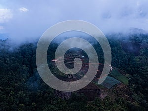 Aerial view of the trees in the valley with fog in the morning. Landscape of misty valley and mountain clouds in thailand. The