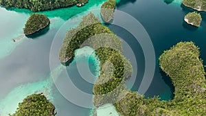 Aerial View Of Triton Bay In Raja Ampat Islands: Lagoon With Turquoise Water And Green Tropical Trees. Wide Angle Nature photo