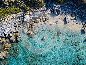 Aerial view of Tropea beach, crystal clear water and rocks that appear on the beach. Calabria, Italy. Swimmers, bathers floating