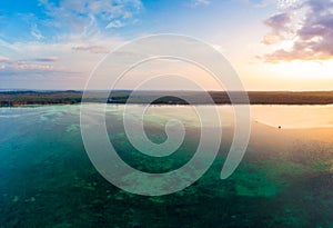 Aerial view tropical beach island reef caribbean sea dramatic sky at sunset sunrise. Indonesia Moluccas archipelago, Kei Islands,