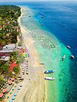 Aerial view of a tropical beach resort next to a coral reef on a small island (Gili Air, Indonesia