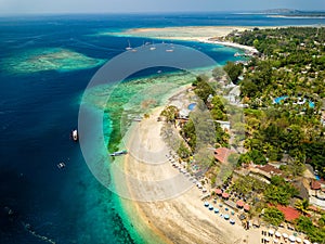Aerial view of a tropical beach resort next to a coral reef on a small island (Gili Air, Indonesia