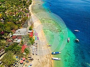 Aerial view of a tropical beach resort next to a coral reef on a small island (Gili Air, Indonesia