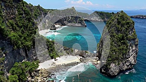 Aerial view of tropical beach, sea rocks, turquoise ocean. Atuh beach, Nusa Penida island, Bali, Indonesia. travel