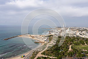 Aerial view of a tropical beach and the vast expanse of the skyline of Tel Aviv, Israel