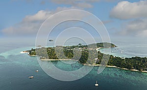 Aerial view of a Tropical island beach with seashore as the tropical island in a coral reef ,blue and turquoise sea background