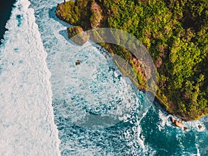 Aerial view of tropical island with cliff, rocks and ocean in Bali